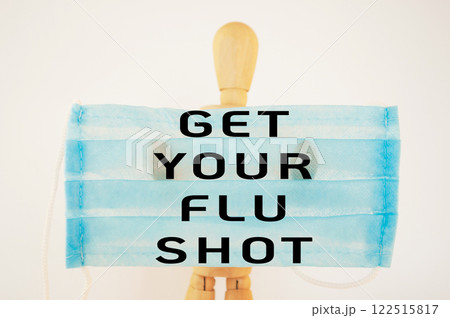 Man wearing a blue mask with the words get your flu shot written on it Man wearing a blue mask with the words get your flu shot written on it 122515817