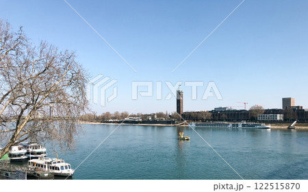 Calm river with a few boats floating on it 122515870