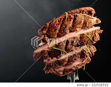 Grilled ribeye beef steak with rosemary on a black background. 122516533