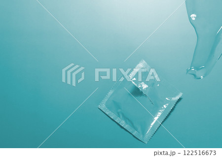 Condom in open package, lubricant. Image can be used as background 122516673