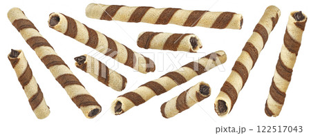 Waffle rolls, striped chocolate and vanilla wafer sticks isolated on white background, full depth of field, package design element 122517043