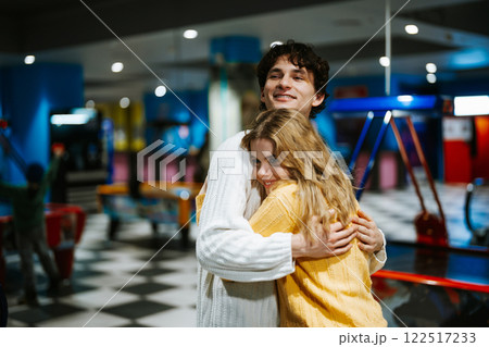 Young couple enjoys a fun moment at an arcade in a vibrant gaming center Young couple enjoys a fun moment at an arcade in a vibrant gaming center 122517233