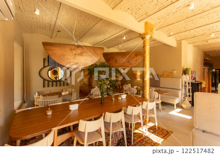 The inviting interior of a coffee shop adorned with warm colors The inviting interior of a coffee shop adorned with warm colors 122517482