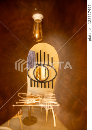 The inviting interior of a coffee shop adorned with warm colors 122517497