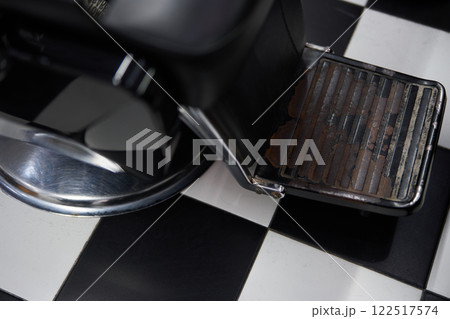 Vintage barber chair with checkered flooring in a classic barbershop Vintage barber chair with checkered flooring in a classic barbershop 122517574