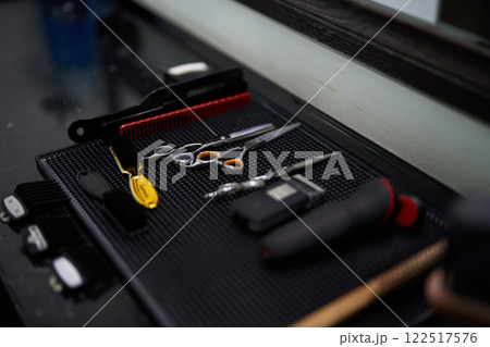 Tools and equipment arranged on a table in a barbershop setting Tools and equipment arranged on a table in a barbershop setting 122517576