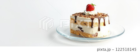 Delicious layered cake with frosting and strawberry served on a glass plate in a bright kitchen setting 122518145