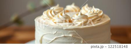 Beautifully decorated cream cake with swirled frosting on top, perfect for celebrations and gatherings 122518148