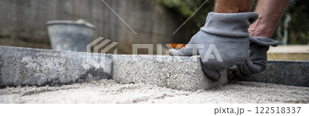 Construction worker paving a sidewalk 122518337