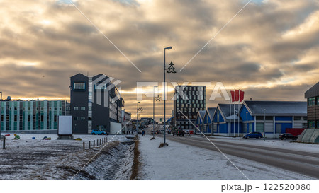Downtown modern buildings and Aqqusinersuaq the main street of Nuuk city covered in snow in a sunset lights, Greenland Downtown modern buildings and Aqqusinersuaq the main street of Nuuk city covered in snow in a sunset lights, Greenland 122520080