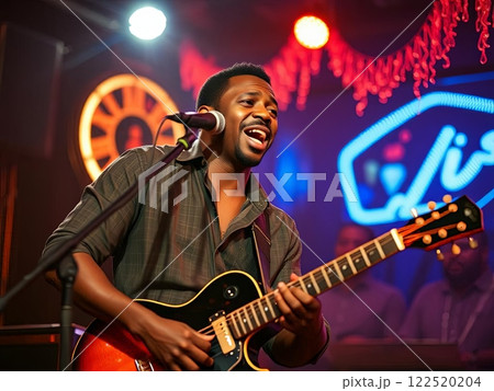 Man Singing and Playing Guitar at Live Event Man Singing and Playing Guitar at Live Event 122520204