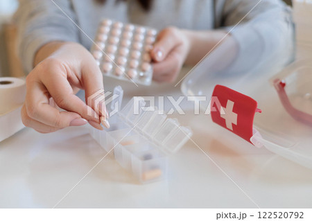 A woman takes her daily sedative or medicine for a headache or stomach pain. A woman takes her daily sedative or medicine for a headache or stomach pain. 122520792