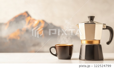 classic moka pot with steaming cup of coffee against mountain backdrop classic moka pot with steaming cup of coffee against mountain backdrop 122524799