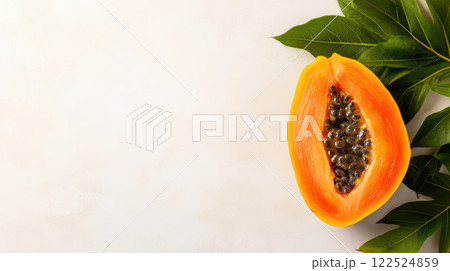 Fresh half cut papaya with seeds and green leaves on light background 122524859