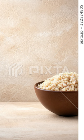 ceramic bowl filled with raw quinoa grains on textured background 122524905