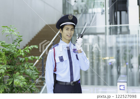 オフィスビルでトランシーバーで会話する若い警備員　撮影協力:スカパー東京メディアセンター 122527098