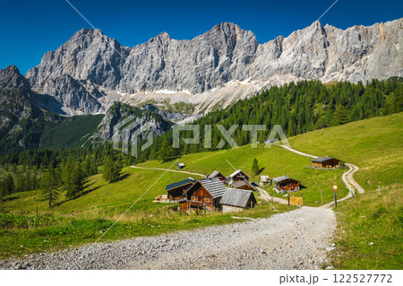 Scattered wooden chalets on the slope, Ramsau am Dachstein, Austria Scattered wooden chalets on the slope, Ramsau am Dachstein, Austria 122527772