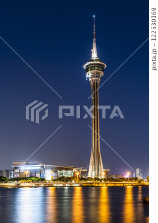 Beautiful night view of Macau Tower and Sai Van Bridge crossing Praia Grande Bay (Nam Van) and connecting Taipa Island and Macau Peninsula. Amazing Macao skyline. Beautiful night view of Macau Tower and Sai Van Bridge crossing Praia Grande Bay (Nam Van) and connecting Taipa Island and Macau Peninsula. Amazing Macao skyline. 122530169