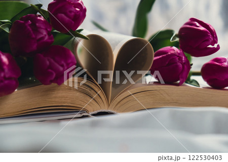 Heart shaped book pages for romantic love greeting card template. Fresh bouquet of pink tulip flowers. Gift present idea for holiday birthday 8 March Mother's Day Valentine's day Women's Day Heart shaped book pages for romantic love greeting card template. Fresh bouquet of pink tulip flowers. Gift present idea for holiday birthday 8 March Mother's Day Valentine's day Women's Day 122530403