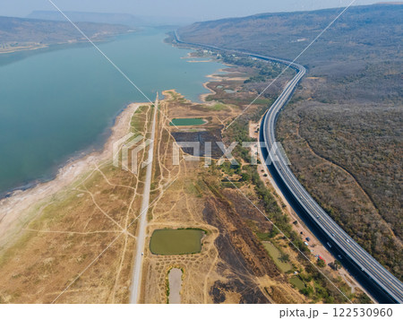 Drone shot aerial view landscape of the M6 motorway Expressway Nakhon Ratchasima Province - Bang Pa-in. Lam Ta Khong River and Mountain. Drone shot of scenic landscape rural place traffic. Nakhon Drone shot aerial view landscape of the M6 motorway Expressway Nakhon Ratchasima Province - Bang Pa-in. Lam Ta Khong River and Mountain. Drone shot of scenic landscape rural place traffic. Nakhon 122530960