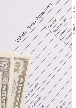 Form of vehicle sales agreement and dollar banknotes. Sales, purchases new or used vehicle 122531666