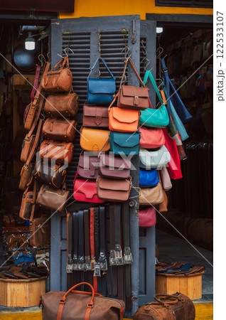 handmade leather bags, belts and accessories on counter in shop at street market in Hoi An in Vietnam in Asia handmade leather bags, belts and accessories on counter in shop at street market in Hoi An in Vietnam in Asia 122533107