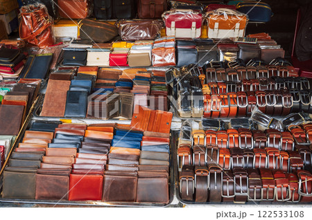 handmade leather wallets, belts and accessories on counter at a street market in Hoi An in Vietnam in Asia 122533108