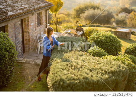 Woman in Rustic Garden Woman in Rustic Garden 122533476