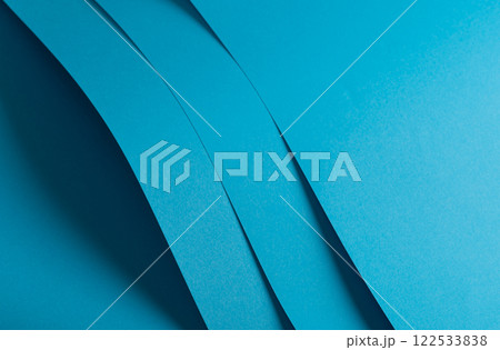 Blue paper background with a smooth matte finish and layered geometric accents. Bright pastel tones 122533838