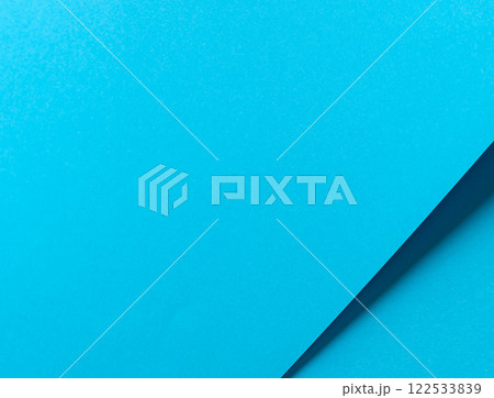 Blue paper background with a smooth matte finish and layered geometric accents. Bright pastel tones 122533839