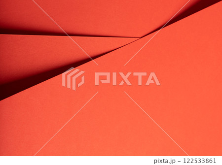 Fiesta red and orange paper background with a matte finish and intersecting, smooth layers. Vibrant, 122533861