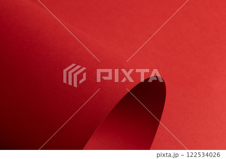 Red paper background with a matte texture and soft tones. Bold ruby and crimson hues create a Red paper background with a matte texture and soft tones. Bold ruby and crimson hues create a 122534026
