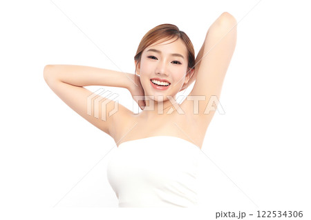 Beautiful Young Asian woman lifting hands up to show off clean and hygienic armpits or underarms on white background, Smooth armpit cleanliness and protection concept 122534306