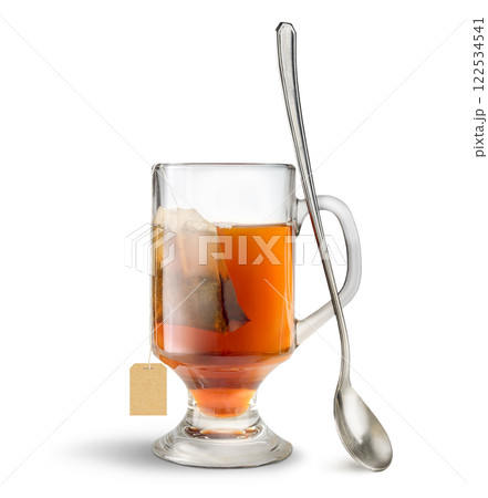 Tall glass of tea with tea bag and spoon isolated on white 122534541