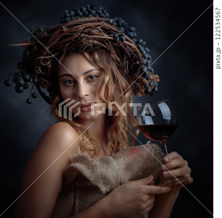 Beautiful blonde with long, wavy hair holding a glass of red wine. 122534567