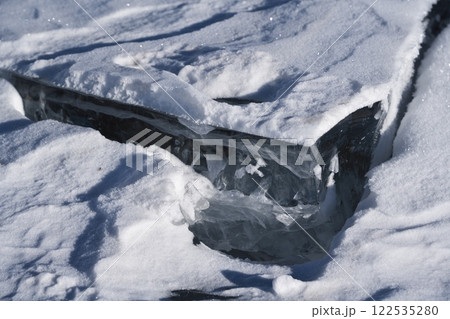 全面凍結した糠平湖の割れた氷の断面と靴の足跡 122535280