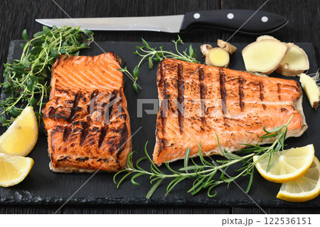 grilled salmon fish fillet with herbs, top view grilled salmon fish fillet with herbs, top view 122536151