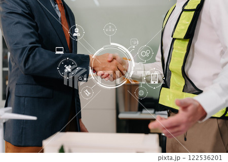 rchitects and engineers shake hands while working for teamwork and cooperation after completing an agreement in an office facility, successful cooperation concept. 122536201