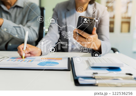 Artificial Intelligence technology. Businessman using a smartphone and laptop computer chatting with an intelligent artificial intelligence. 122536256