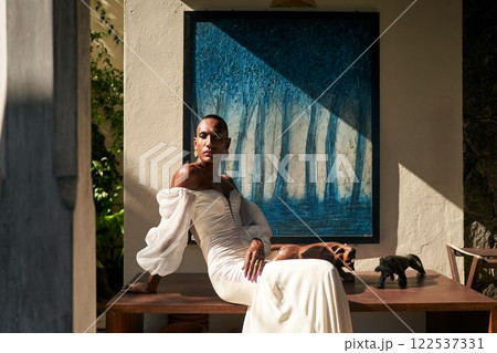 Ambiguous gender fluid, white bridal dress, modern villa. LGBTQ inclusive non-binary fashion. Trendy wedding, diverse attire. Artistic photo for gay friendly boutique, pride, inclusive marketing. Ambiguous gender fluid, white bridal dress, modern villa. LGBTQ inclusive non-binary fashion. Trendy wedding, diverse attire. Artistic photo for gay friendly boutique, pride, inclusive marketing. 122537331