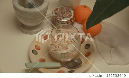 Overnight oat with nuts and raisins served on a table in a cozy springtime breakfast setup showing a relaxing and healthy morning routine Overnight oat with nuts and raisins served on a table in a cozy springtime breakfast setup showing a relaxing and healthy morning routine 122538440