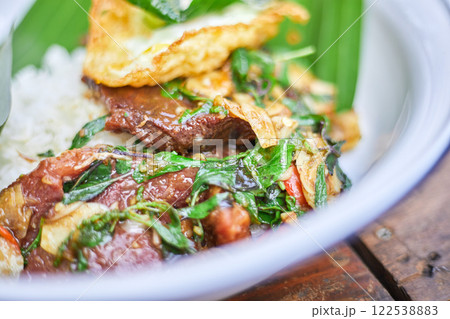 Thai style holy Basil beef stir fry with fried egg. 122538883