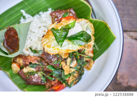 Thai style holy Basil beef stir fry with fried egg. 122538886