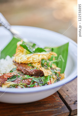 Thai style holy Basil beef stir fry with fried egg. 122538895