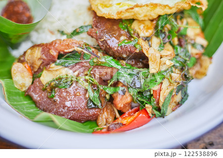 Thai style holy Basil beef stir fry with fried egg. 122538896