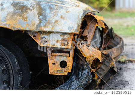 Close-up of burnt wheel. Black charred tire with wire cord. 122539513