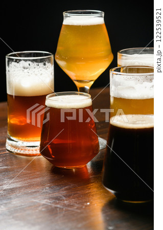 Variety of beer glasses with different types of beer on wooden table. Close-up. 122539521