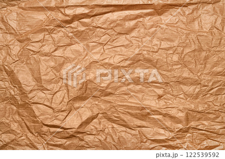 A seamless crumpled brown paper texture ideal for background use, perfect for creative multimedia projects, vintage aesthetics, or craft-themed stock photo A seamless crumpled brown paper texture ideal for background use, perfect for creative multimedia projects, vintage aesthetics, or craft-themed stock photo 122539592