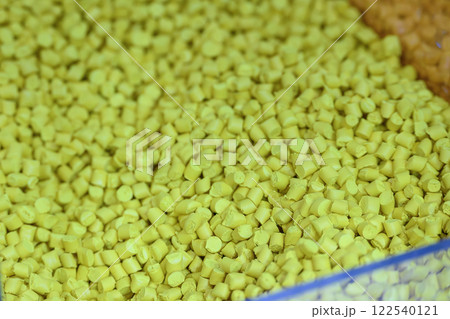 The pile of yellow pellets materials for plastic injection process. 122540121