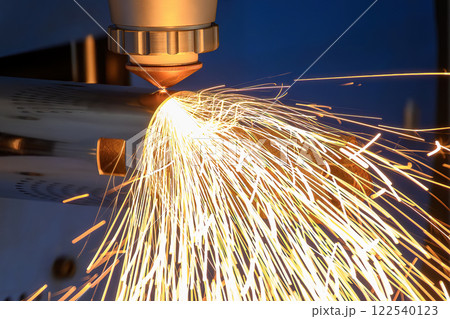 Close up scene the fiber laser cutting machine cut the stainless steel tube and sparkling light. 122540123
